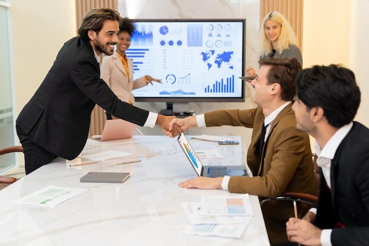 successful-businesspeople-shaking-hands-while-making-agreement-ornamented_31965-296886